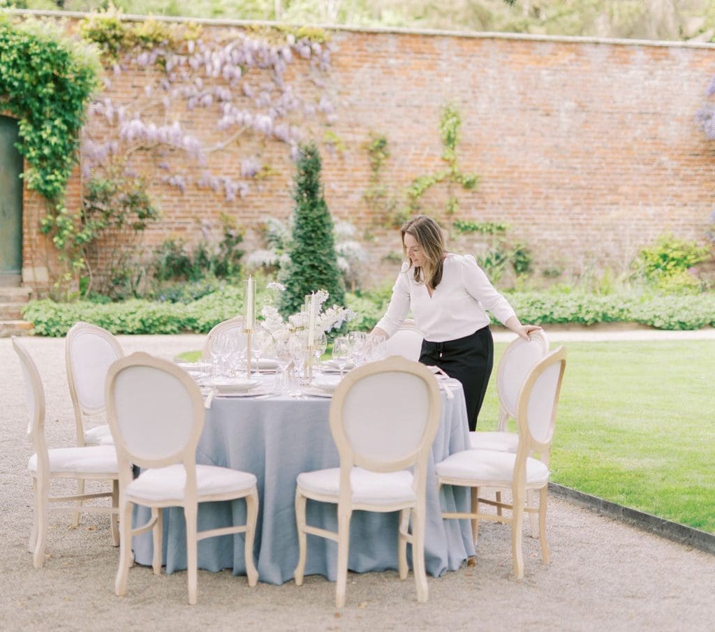 Lauren Wright of LMJ Weddings & Events styling a luxury wedding tablescape at Garthmyl Hall
