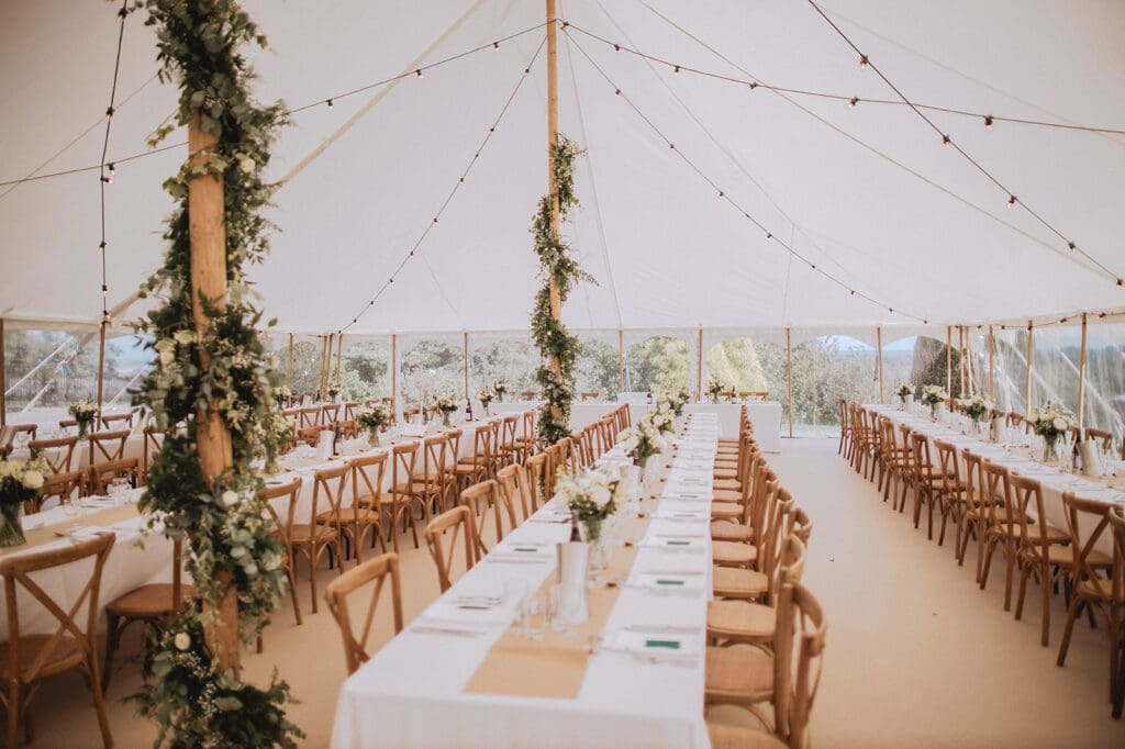 Sperry tent interior with trestle tables setup by LMJ Weddings & Events
