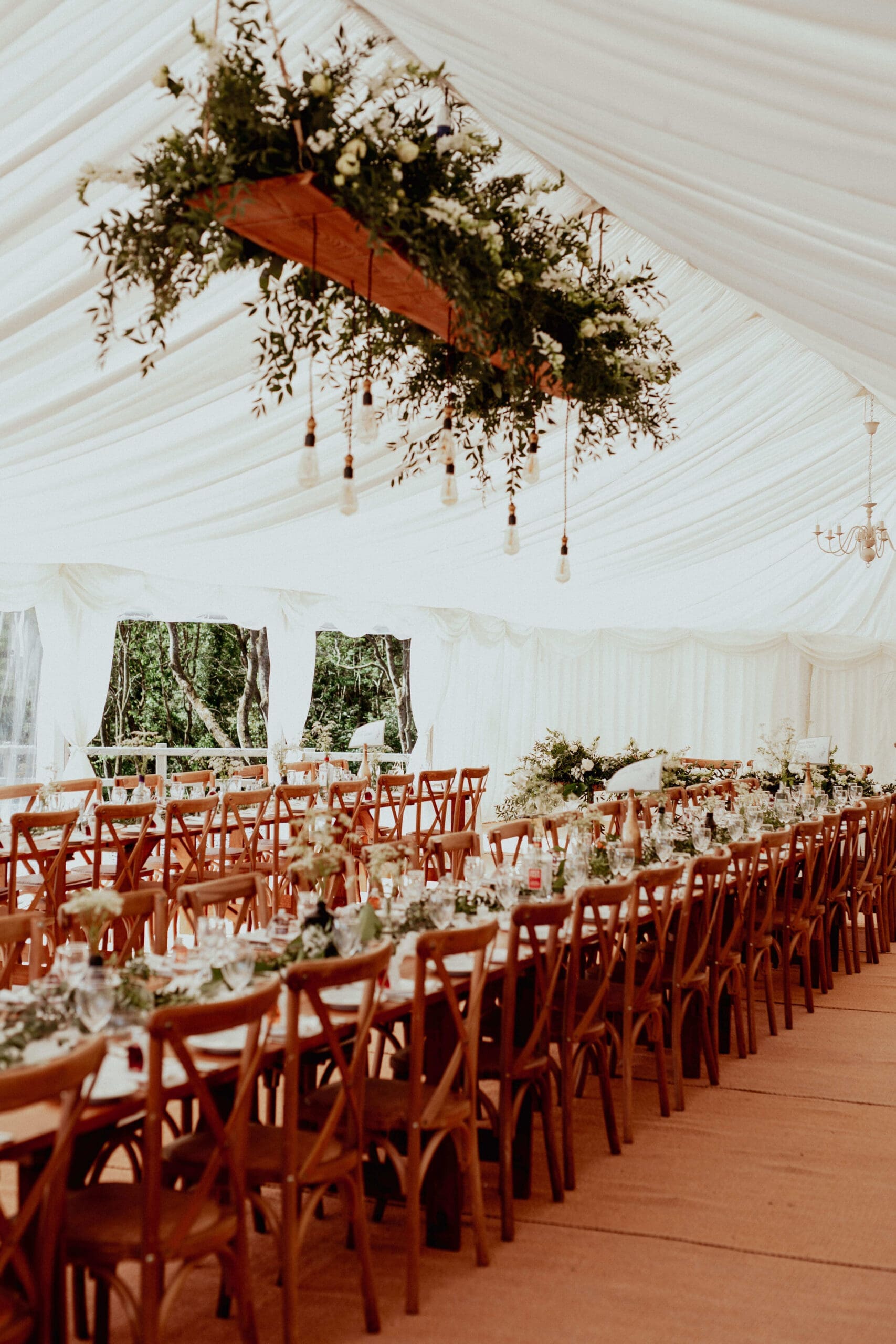 marquee wedding table setup with hanging floral installation